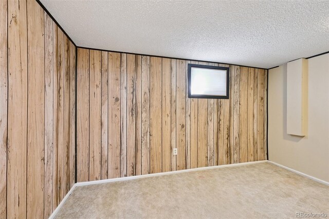 8250 Chase Way, Arvada, CO 80003 - finished basement featuring wood walls, a textured ceiling, and carpet