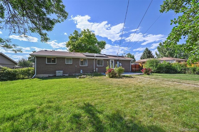 8250 Chase Way, Arvada, CO 80003 - back of property with roof mounted solar panels and brick siding