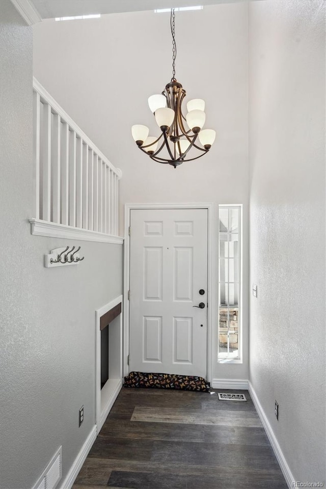 5193 E 119th Way, Thornton, CO 80233 - entryway featuring a chandelier, wood finished floors, and baseboards