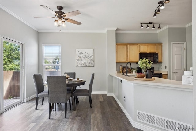 5193 E 119th Way, Thornton, CO 80233 - dining space with wood finished floors, rail lighting, ceiling fan, baseboards, and ornamental molding