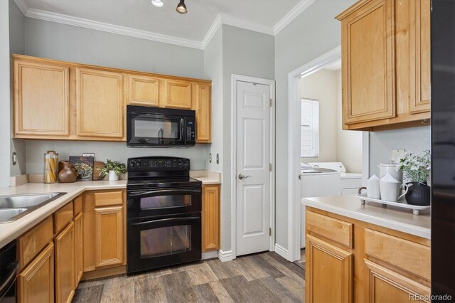 5193 E 119th Way, Thornton, CO 80233 - kitchen with black appliances, separate washer and dryer, dark wood-style floors, light countertops, and crown molding