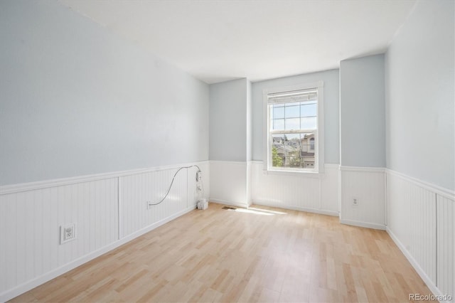 5193 E 119th Way, Thornton, CO 80233 - unfurnished room featuring wood finished floors and a wainscoted wall