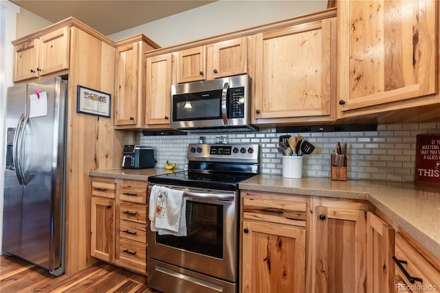 kitchen featuring decorative backsplash, light brown cabinets, appliances with stainless steel finishes, and dark hardwood / wood-style flooring