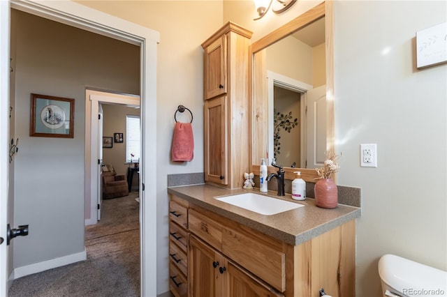 bathroom with toilet and vanity