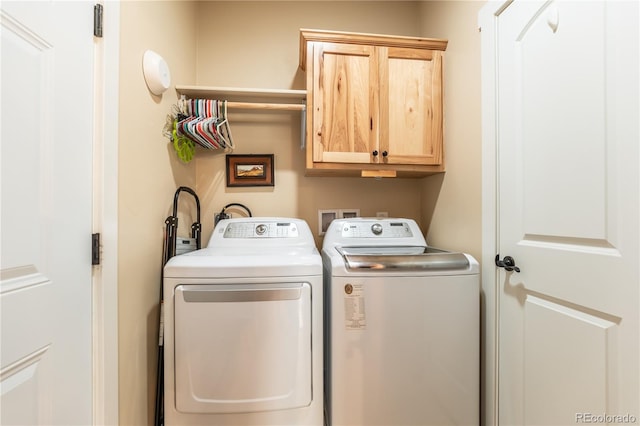 laundry room with cabinets and washer and dryer