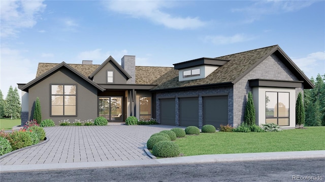 view of front of house with a garage and a front yard