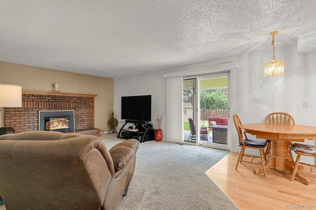 7784 Lewis St, Arvada, CO 80005 - living room with a textured ceiling, a fireplace, and wood finished floors