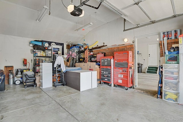 7784 Lewis St, Arvada, CO 80005 - garage with a garage door opener and wood walls