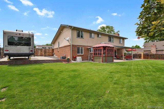 7784 Lewis St, Arvada, CO 80005 - back of house featuring a gazebo, a patio, a fenced backyard, brick siding, and a chimney