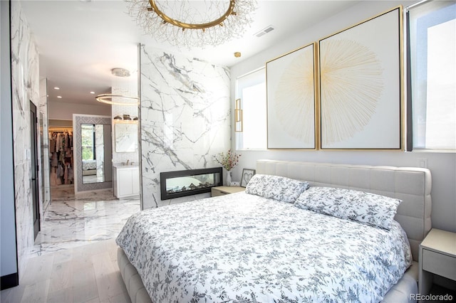 bedroom with a notable chandelier and light wood-type flooring