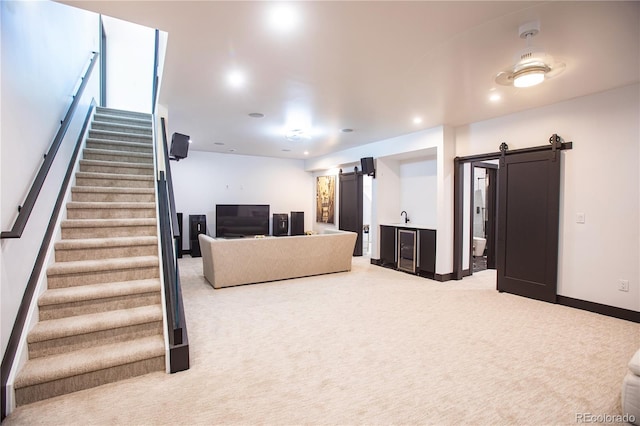 carpeted living room featuring a barn door