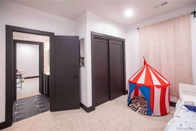 carpeted bedroom with a closet