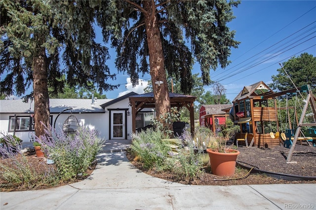 view of front of home with a gazebo and a playground