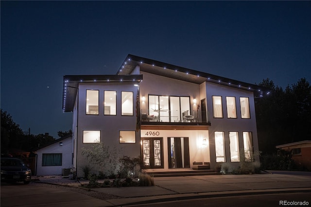 view of front facade with french doors and a balcony