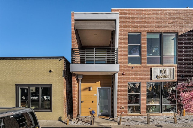 4258 Tennyson St Unit 104, Denver, CO 80212 - rear view of house featuring a balcony and brick siding