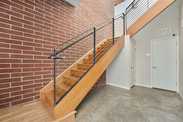 4258 Tennyson St Unit 104, Denver, CO 80212 - stairs with a high ceiling and brick wall