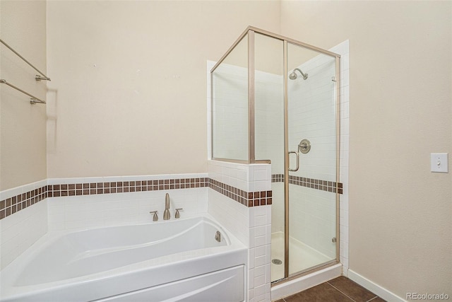 4258 Tennyson St Unit 104, Denver, CO 80212 - bathroom featuring a bath, a stall shower, and tile patterned floors