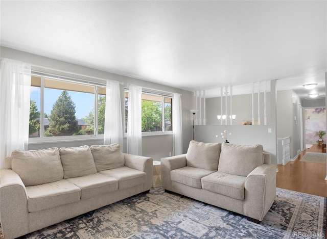 2502 S Lima St, Aurora, CO 80014 - living room featuring a chandelier and wood finished floors