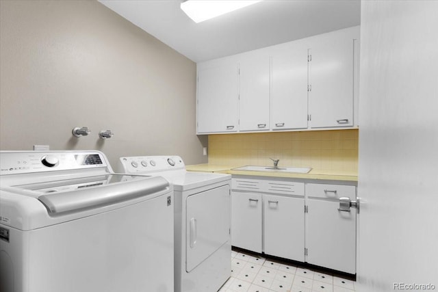 2502 S Lima St, Aurora, CO 80014 - washroom with washer and dryer, cabinet space, and light floors