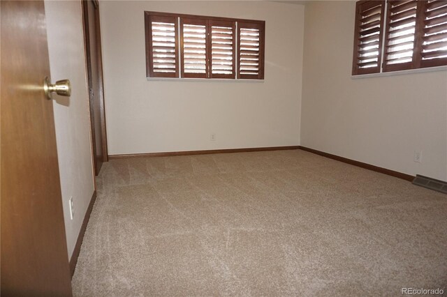 4130 Aspen Ln, Evergreen, CO 80439 - carpeted empty room with baseboards, a healthy amount of sunlight, and visible vents
