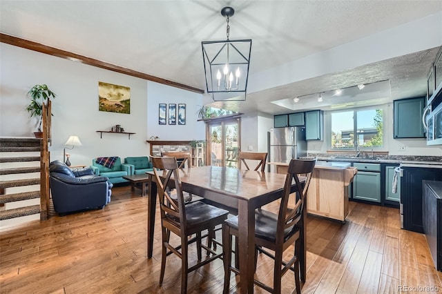 10806 W Evans Ave Unit 5, Lakewood, CO 80227 - dining area featuring wood-type flooring, stairway, a chandelier, and a textured ceiling
