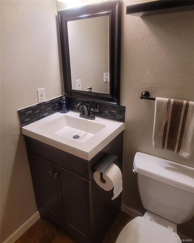 10806 W Evans Ave Unit 5, Lakewood, CO 80227 - bathroom with baseboards, decorative backsplash, and toilet