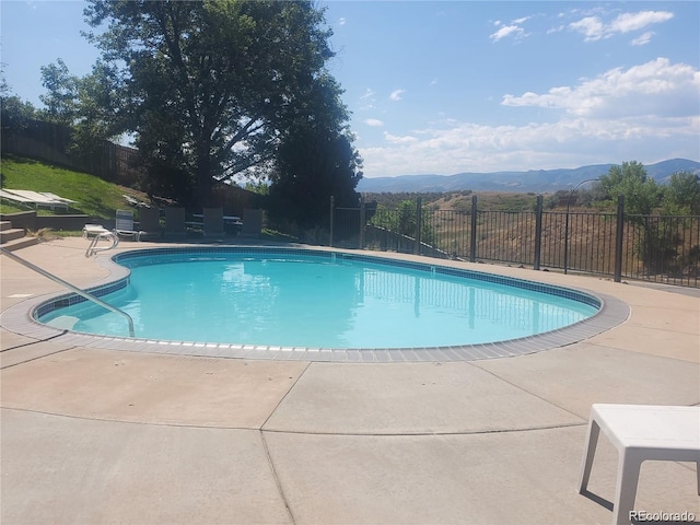 10806 W Evans Ave Unit 5, Lakewood, CO 80227 - view of pool featuring a mountain view and a patio area