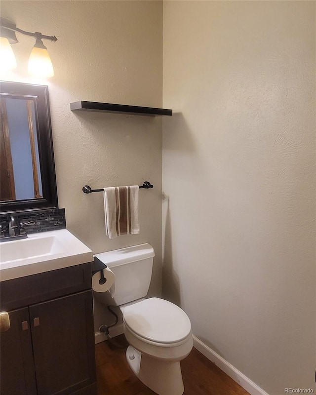 10806 W Evans Ave Unit 5, Lakewood, CO 80227 - half bathroom with vanity, wood finished floors, toilet, and baseboards