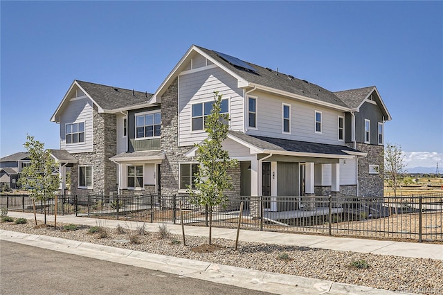 95 N Vandriver Pl, Aurora, CO 80018 - view of front of property with a fenced front yard, stone siding, and a porch