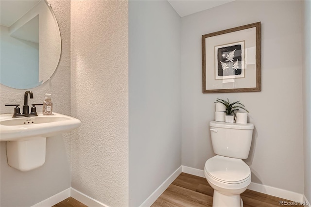 95 N Vandriver Pl, Aurora, CO 80018 - half bathroom with wood finished floors, toilet, baseboards, and a textured wall