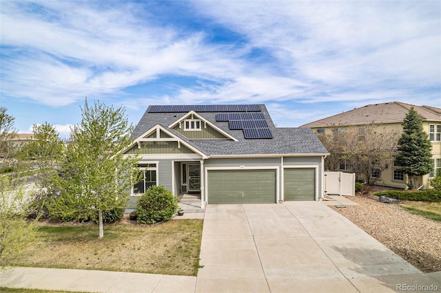 4873 Cathay Ct, Denver, CO 80249 - craftsman house featuring fence, driveway, a garage, roof mounted solar panels, and board and batten siding