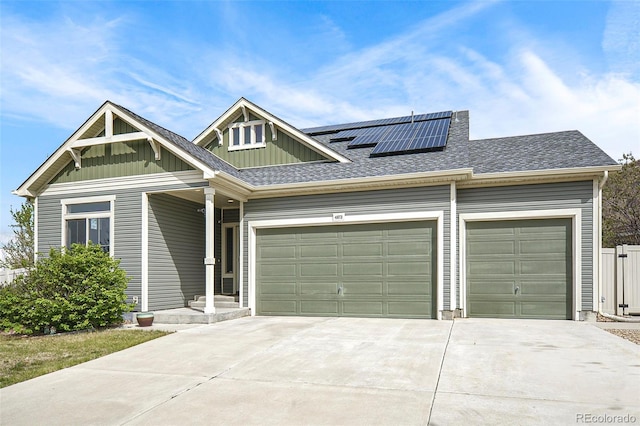 4873 Cathay Ct, Denver, CO 80249 - craftsman-style house featuring a garage, concrete driveway, board and batten siding, a shingled roof, and solar panels