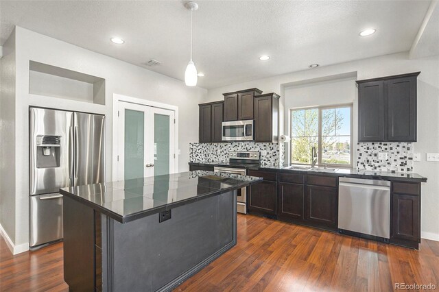 4873 Cathay Ct, Denver, CO 80249 - kitchen featuring a sink, backsplash, dark countertops, and appliances with stainless steel finishes