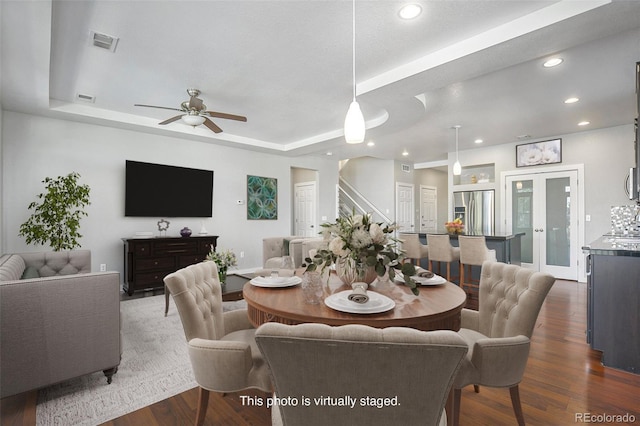 4873 Cathay Ct, Denver, CO 80249 - dining area featuring a tray ceiling, a ceiling fan, recessed lighting, dark wood-style floors, and baseboards