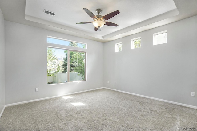 4873 Cathay Ct, Denver, CO 80249 - carpeted empty room featuring a tray ceiling, baseboards, and a ceiling fan