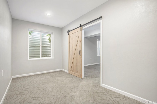 4873 Cathay Ct, Denver, CO 80249 - unfurnished bedroom with baseboards, recessed lighting, a barn door, and carpet