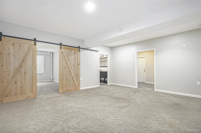 4873 Cathay Ct, Denver, CO 80249 - below grade area featuring a barn door, carpet, and baseboards