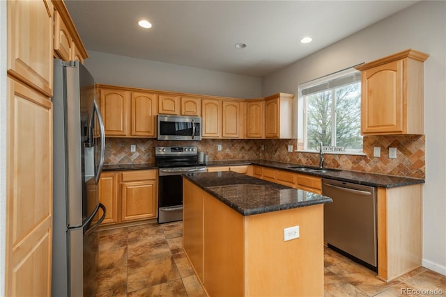 kitchen with stainless steel appliances, a kitchen island, a sink, backsplash, and dark stone counters