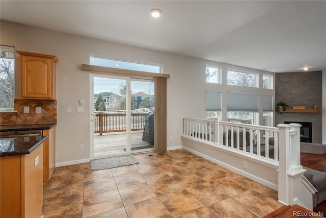 entryway with a fireplace and baseboards