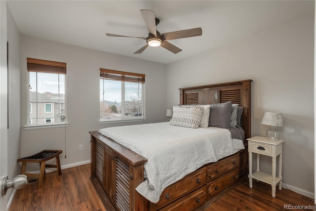 bedroom featuring a ceiling fan, dark wood-style flooring, and baseboards