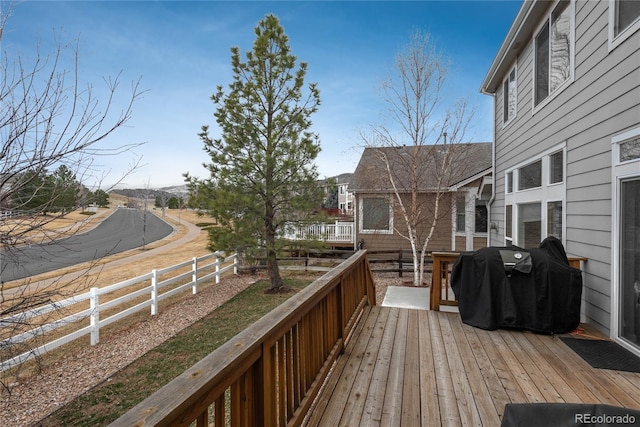 wooden deck featuring area for grilling and fence