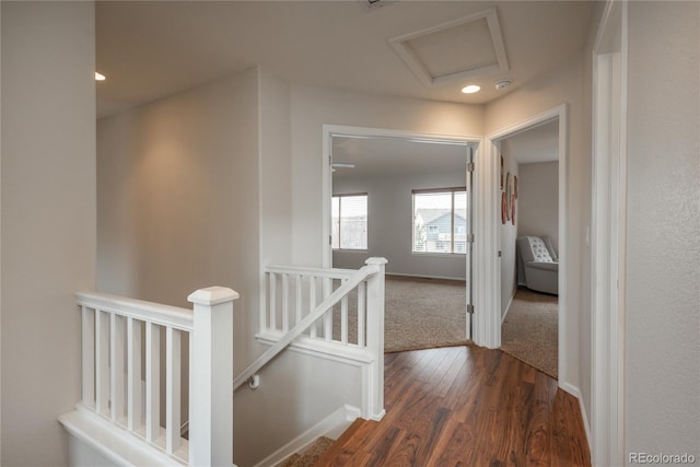 hall featuring attic access, recessed lighting, baseboards, dark wood-style flooring, and an upstairs landing