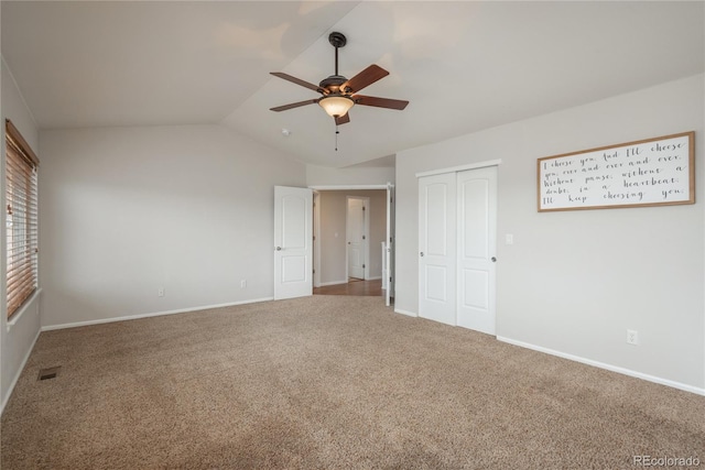 unfurnished bedroom featuring vaulted ceiling, carpet, visible vents, and baseboards
