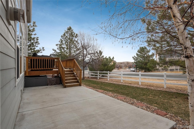 view of patio with stairs, a wooden deck, and fence