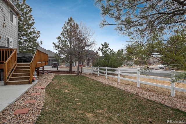 view of yard with fence, stairs, and a wooden deck