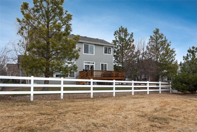 view of front of home with fence private yard and a wooden deck