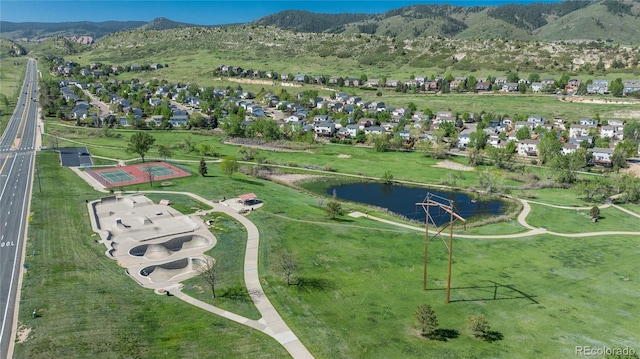 7506 Chipmunk Pl, Littleton, CO 80125 - aerial overview of property's location featuring a mountain backdrop and nearby suburban area