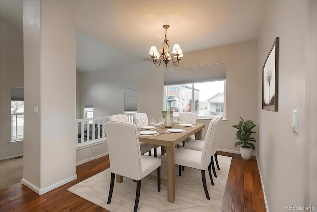 7506 Chipmunk Pl, Littleton, CO 80125 - dining space featuring a chandelier, wood finished floors, baseboards, and lofted ceiling