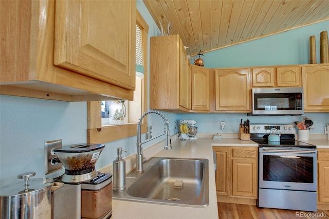 kitchen featuring a sink, wooden ceiling, light countertops, light brown cabinets, and appliances with stainless steel finishes