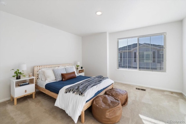 carpeted bedroom featuring visible vents and baseboards